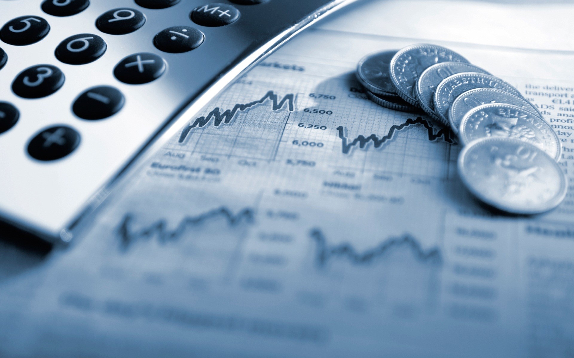 stock image of a calculator, coins, and financial reports