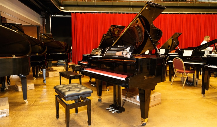 A room full of mini grand pianos 